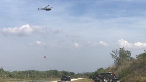 Helicopter carrying a bucket