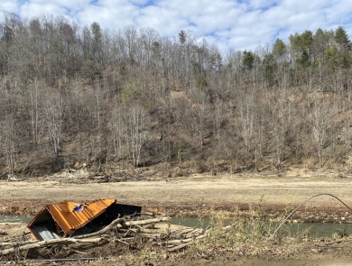 A crumpled shipping container in the Cane River.