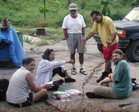 Ruth Utzurrum, second from left, is sitting on the ground with other researchers in American Samoa. 