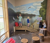 Children using the magnetic fishing exhibit in the visitor center.