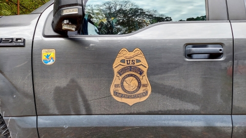 A photo of the USFWS law enforcement emblem on a truck door.