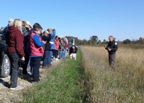 Visitors standing in road listening as Big Oaks manager explains grassland management