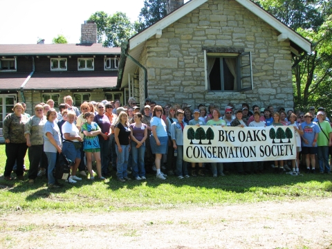 A large group of woman standing by the Big Oaks Conservation Society banner at Big Oaks NWR