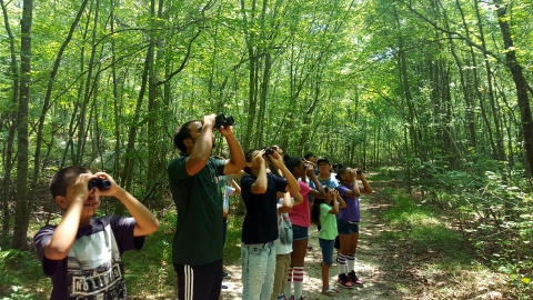 Providence students on a field trip at Ninigret NWR viewing spotting forested upland birds!