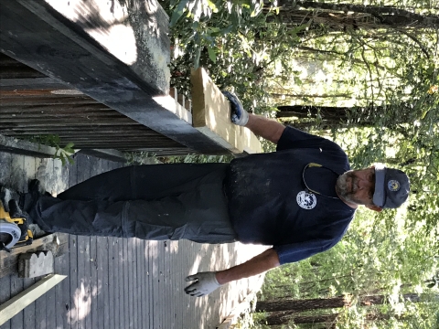 Volunteer Jim Hamberger repairs hand rail of bridge on the Nebo Trail