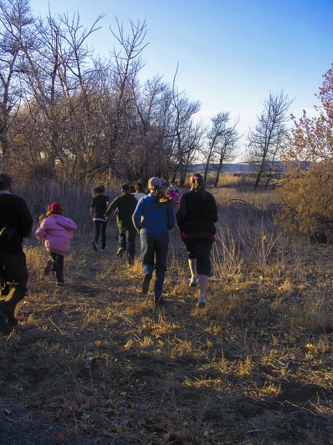 People walk along a trail at the Modoc NWR.