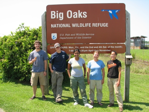 Group of volunteers standing by Big Oaks sign