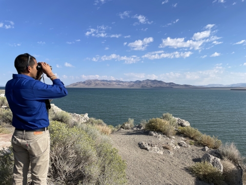 Deputy Director Siva Sundaresan views Pyramid Lake through binoculars at the Popcorn Overlook.