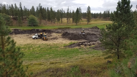 Heavy equipment moving earth as part of a wetland restoration project