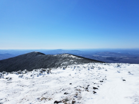 A view from on top of a snow covered mountain in the White Mountains of New Hampshire