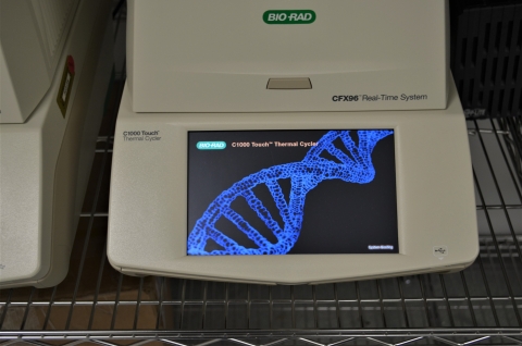 PCR machine with DNA strand on it.