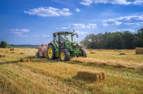 Farm Tractor in hay field