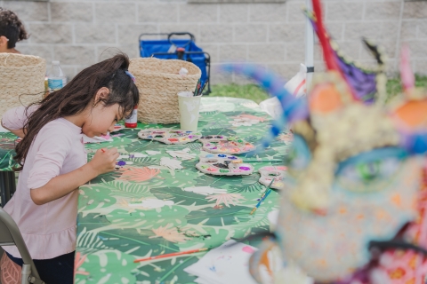 Child painting at the latino conservation week festival