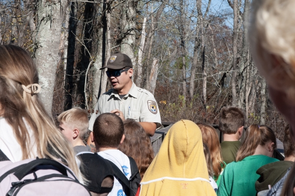 A refuge ranger speaking to a school group