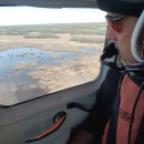 Man looking out a plane window. Jeff Drahota counting ducks in the Yorkton, SK area.