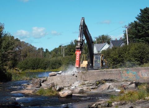large jackhammer removes concrete dam