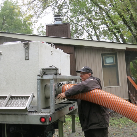 Joseph Kelly connecting hose to distribution truck