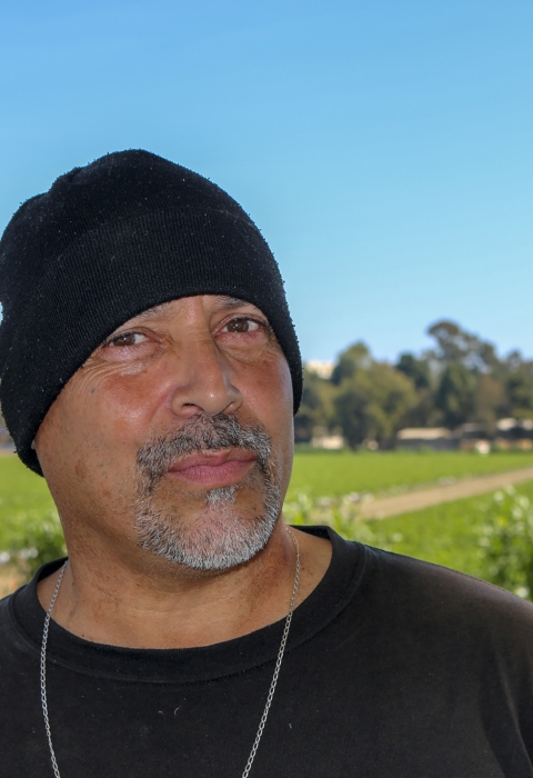 A man wearing a black beanie and black shirt