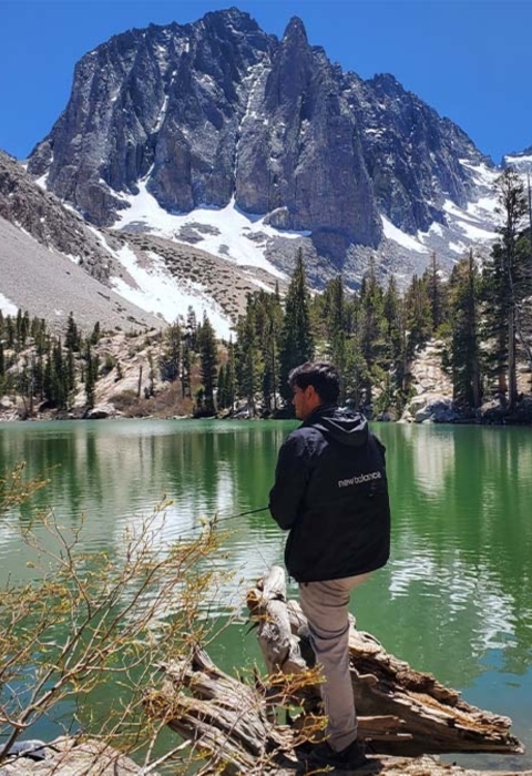 Armando at Big Pines Lake featuring a lake and snow capped mountains