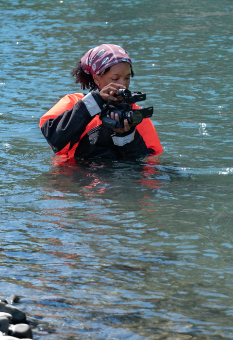 USFWS intern, Typhanie Shepherd, filming on the Elwha River in her drysuit.