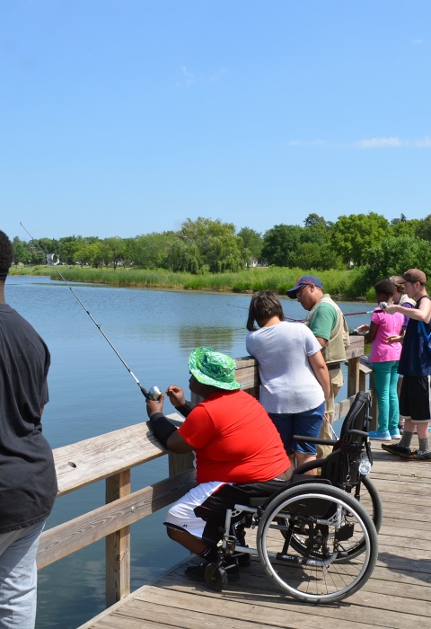 A diverse of anglers on a fishing pier.