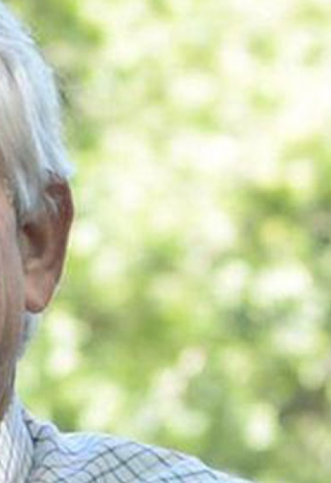 Landowner Dink Nesmith poses in front of a forest.