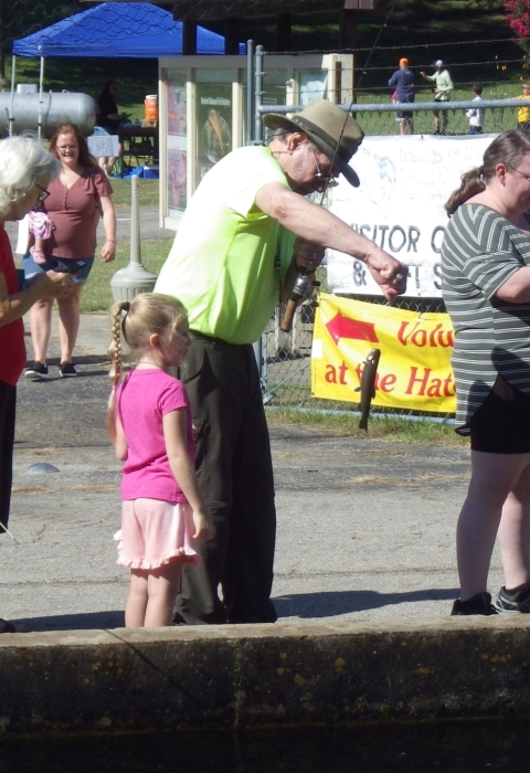children at the hatchery outdoor adventure fishing in a raceway