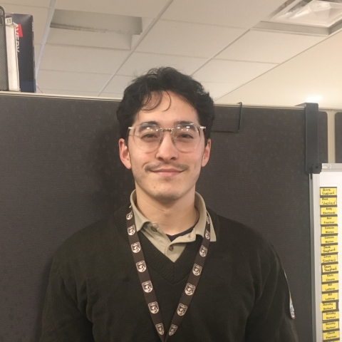 Image of person in FWS uniform with dark hair and glasses