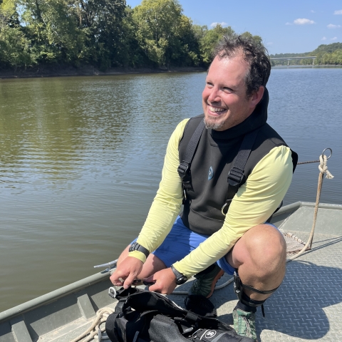 Josh Hundley preparing SCUBA gear on boat