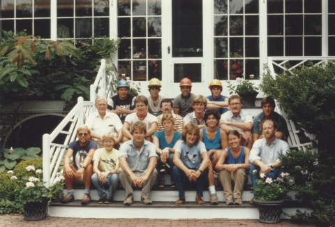 Group of young people sit on front porch of Twyford House