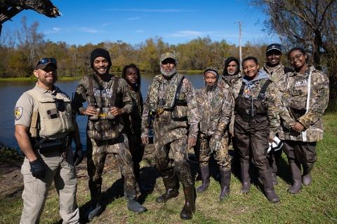 FWS staffer stand with a group of hunters called the 4 W's Team. 