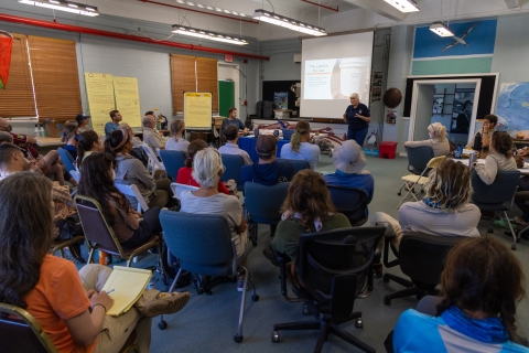 A lead biologist teaches seabird protection project staff about safety and proper use of the rodenticide bait