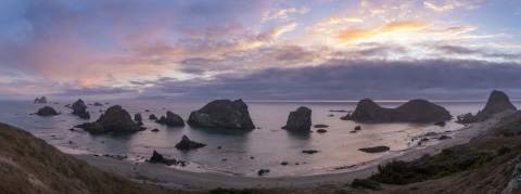 Sunset over a group of offshore rocks