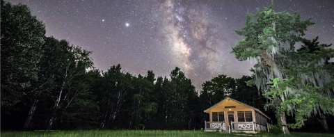 A cabin under a stary sky