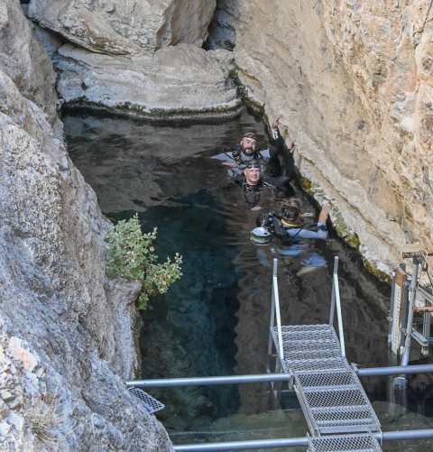three scuba divers in water