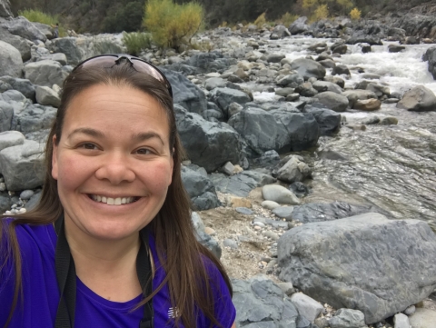 Jen Johnson standing near a river and rocks in northern California