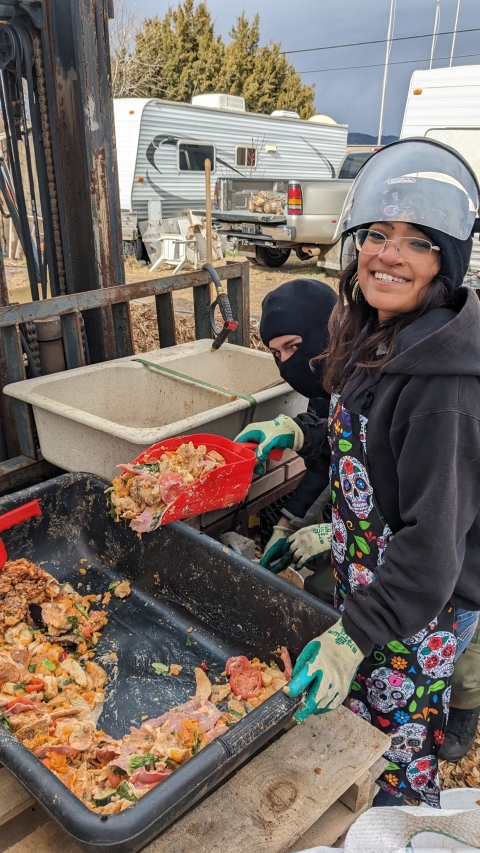 Image of 2 students scooping leftover food