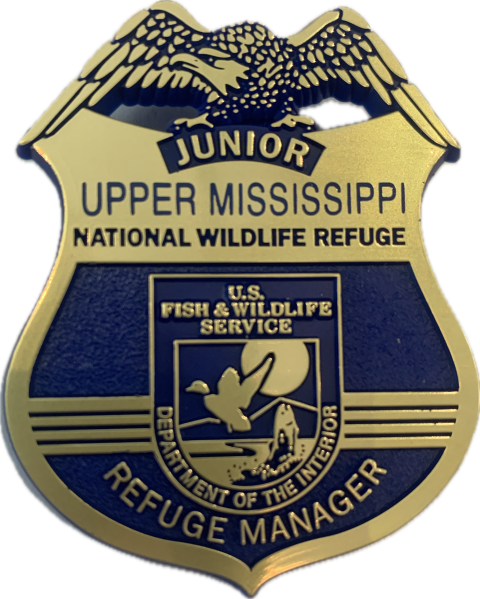 The Upper Mississippi River National Wildlife and Fish Refuge Junior Refuge Manager badge features a blue and gold eagle with wings spread over the name of the refuge and the US Fish and Wildlife Service logo.