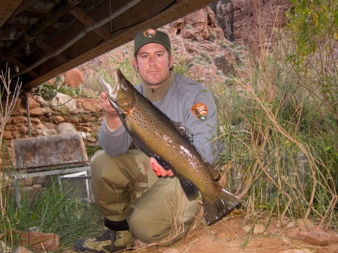A NPS member holding up a fish