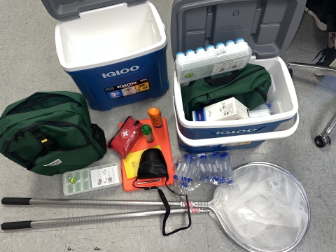 pollinator kits including nets, vials, coolers, backpacks, clipboards, cameras, ice cube trays (for chilling specimens), bug spray, sunscreen, and first aid kits.