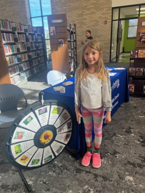 girl standing beside wheel