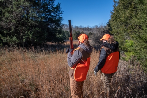 Two women hunting in fall field