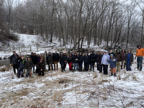 Volunteers pose for group photo after planting trees
