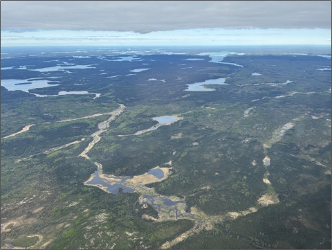 aerial view of landscape with mountains and wetlands
