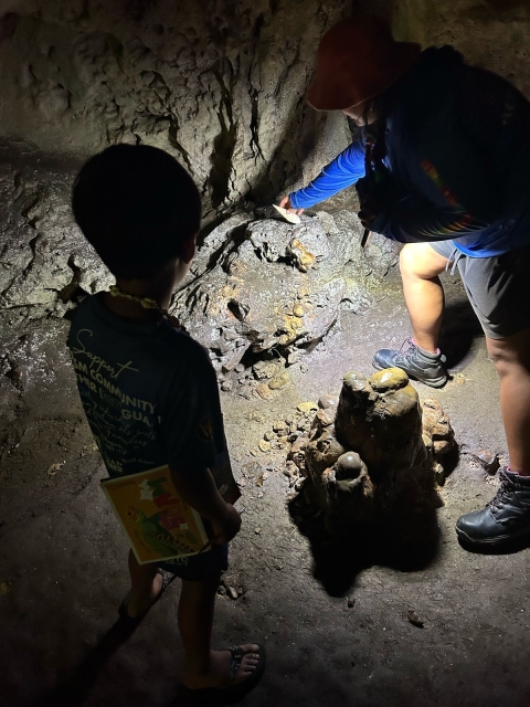 Exploring stalagmites in Ritidian Beach Cave at Guam NWR