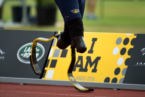 Close-up of two running blades in motion in front of a sign that reads "I am, Orlando 2016."