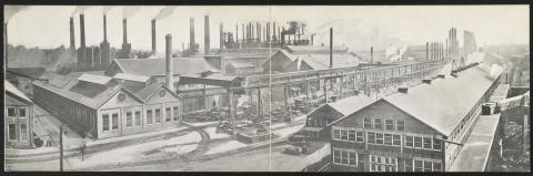 a black-and-white photo of factory buildings and smokestacks
