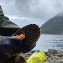 Underside of boot being cleaned with handheld bootbrush.