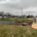 Digitally rendered image of a rain garden with visitors walking around