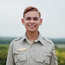 Photo of Logan Sauer with wetland in the background
